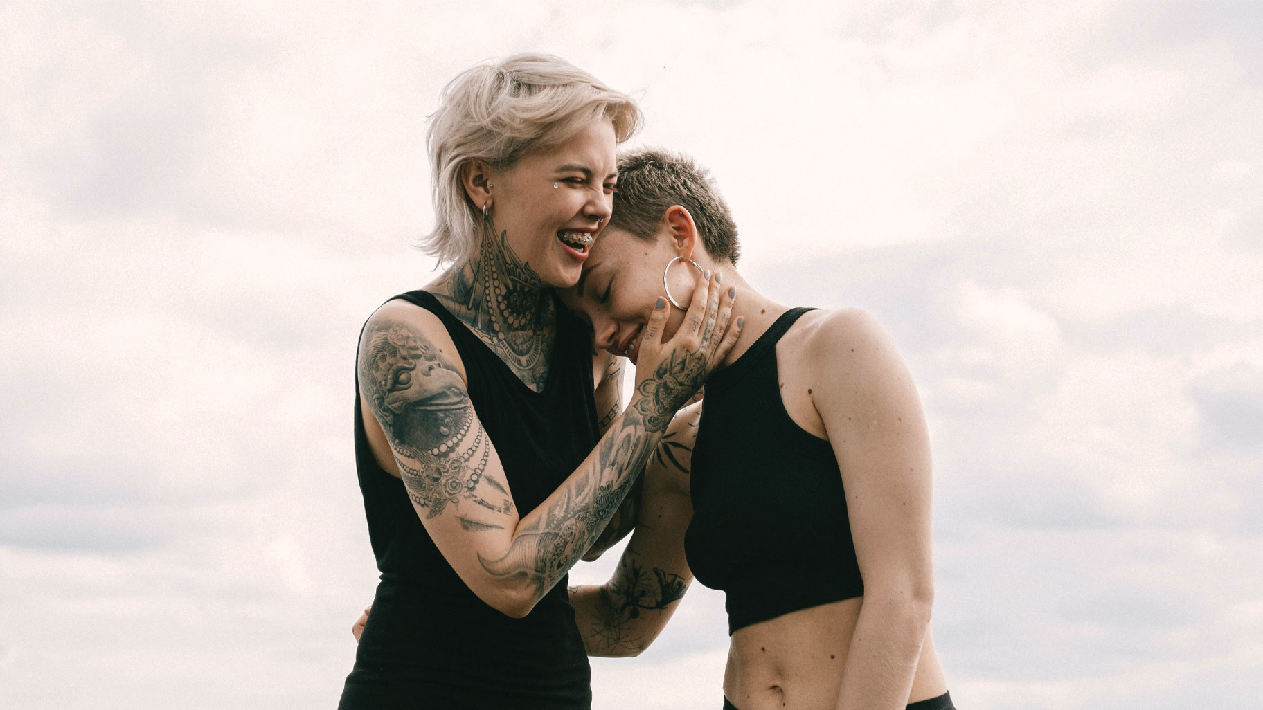 A couple sharing a laugh and holding each other, which symbolizes a strong bond strengthened through relationship counseling.